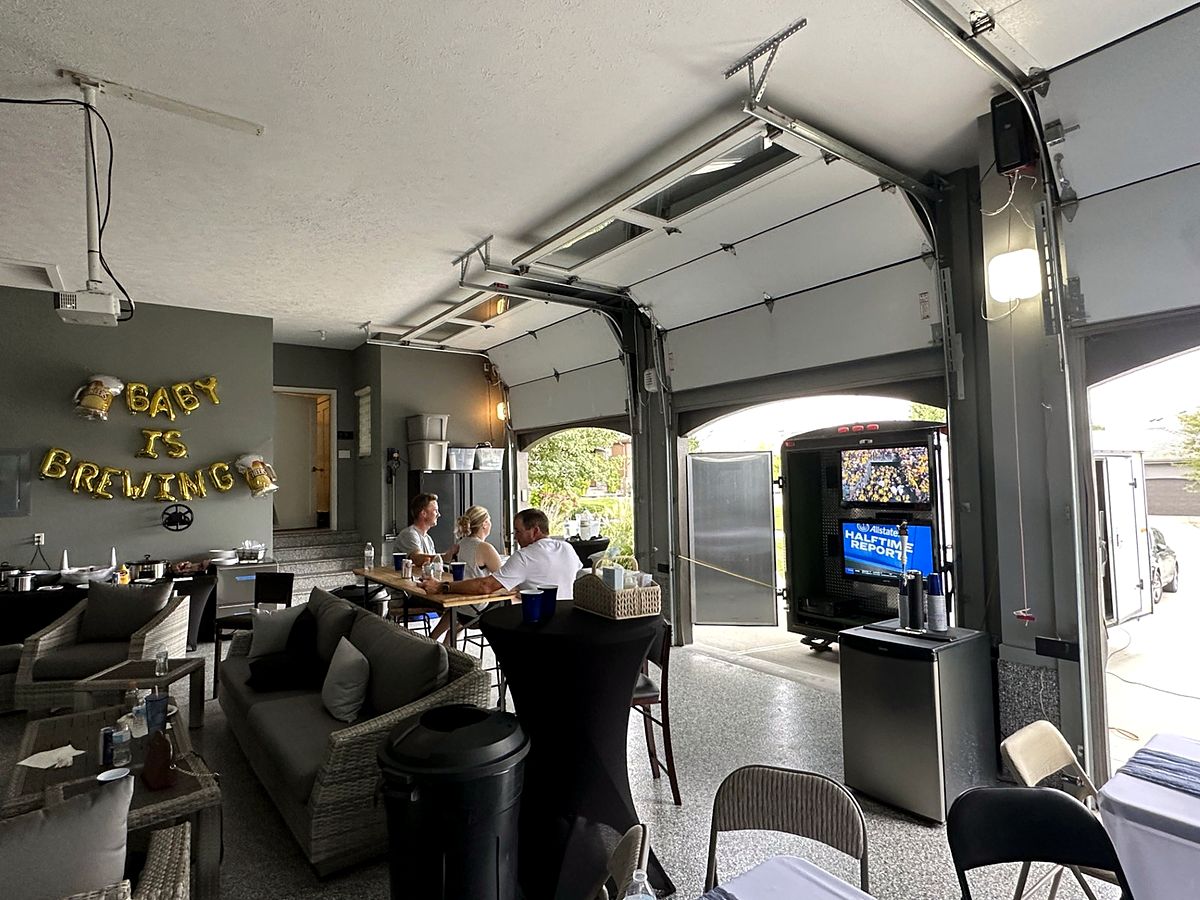 Garage watch party with trailer TVs and lounge seating