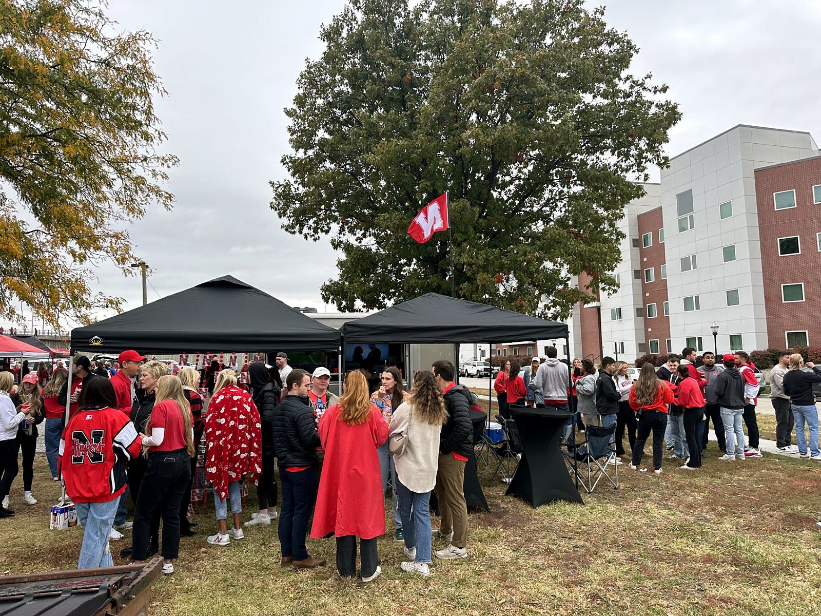 Fans gathered around a Midwest Tailgates setup on game day